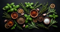 Fresh herbs and spices collection with basil, rosemary, thyme, garlic, dried orange slices and various seasonings in wooden bowls on dark background.