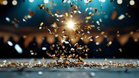 Golden and silver confetti falling with bright light burst against dark blue background, creating festive atmosphere for celebration and party events.