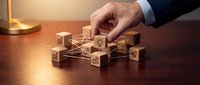 Professional businessman hand arranging wooden blocks with percentage symbols on desk representing financial growth and investment strategy planning.
