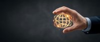 Businessman hand protecting glowing golden globe network symbol representing global business connectivity and worldwide digital transformation.