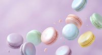 Colorful macarons floating on pastel pink background with golden sprinkles for bakery menu design and confectionery advertising materials.