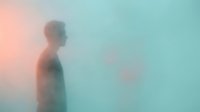 Side profile of a young adult male with light skin tone standing in misty atmosphere, surrounded by soft peachy and turquoise gradient tones, suitable for wellness and mental health concepts.