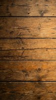 Rustic weathered wooden planks with natural grain patterns and knots creating warm brown textured background for vintage design projects and rustic decor.