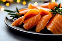Fresh salmon sashimi slices served on dark plate with rosemary garnish and bokeh lights background, close-up view showing vibrant orange color and tender texture.