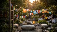 Cozy backyard garden with colorful prayer flags strung between wooden posts, large smooth stones creating peaceful meditation space during golden hour sunset.