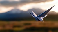 Paper crane origami flying against dramatic sunset sky and mountain silhouette background, symbolizing hope, freedom and mindfulness in nature setting.