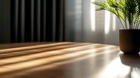 Dramatic morning sunlight casting long shadows through window blinds onto wooden table surface with decorative palm plant in ceramic pot, moody interior.