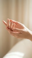 Woman's hands cupped together in open gesture against soft beige background, conveying care, giving, receiving, hope and support for wellness, charity and community concepts.