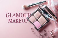 Professional makeup palette with pink and nude eyeshadows, brush and crystals on soft pink background. Glamour cosmetics flatlay for beauty blog and social media.