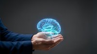 Businessman hand holding glowing digital brain hologram representing artificial intelligence, machine learning and innovative technology solutions.