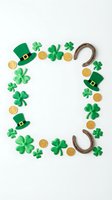 St Patricks Day frame with shamrocks leprechaun hats gold coins horseshoes on white background for Irish holiday celebration design.
