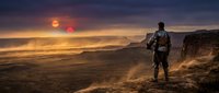 Lone hiker with backpack standing on mountain cliff edge watching dramatic sunset over vast desert landscape with golden light and purple sky.