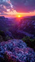 Breathtaking mountain sunset landscape with dramatic purple and orange sky illuminating rocky canyon valleys, perfect for travel inspiration or nature wall art decoration.