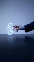 Hand of a person in business attire touching a glowing neon phone icon on a dark reflective surface against a blue background for communication and technology concepts.