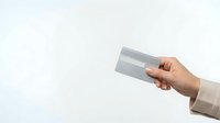 Hand holding blank credit card mockup on white background for financial services and banking design projects.
