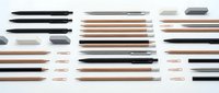 Minimalist makeup brushes and cosmetic tools arranged in organized rows on white background, perfect for beauty product catalogs and design projects.