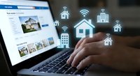 Real estate agent browsing property listings on laptop with digital home icons floating above keyboard representing online property search technology.