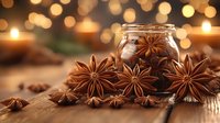 Star anise pods scattered on wooden surface with glass jar and warm glowing bokeh lights in background, creating cozy festive atmosphere for winter holidays.