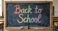 Colorful chalk lettering spelling Back to School on black chalkboard in classroom setting with wooden desks and educational supplies for academic preparation.