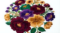 Colorful embroidered floral arrangement featuring burgundy, purple, golden yellow and cream blooms with green leaves on white background, isolated for textile and craft design applications.