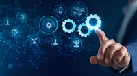 Business professional touching virtual gear icons with glowing network connections on dark blue background, illustrating digital transformation and automation.