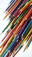 Assorted sharpened colored pencils arranged diagonally on white background, showcasing vibrant hues for art, design, education, and creative projects.