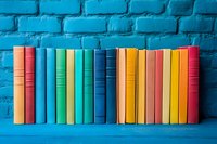 Row of colorful hardcover books arranged on blue wooden shelf against vibrant turquoise brick wall background, creating minimalist composition for education concept.