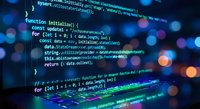 Programming code on computer screen with colorful syntax highlighting and bokeh lights background for software development projects.