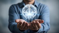 Businessman holding glowing digital brain hologram with neural networks and sparkling lights representing artificial intelligence and innovation.
