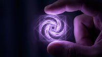 Hand holding glowing purple energy spiral with mystical light effects on dark background for fantasy and supernatural design projects.