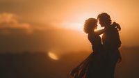 Romantic couple silhouette embracing at golden sunset with mountain landscape backdrop creating intimate moment for love and relationship concepts.