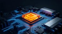 Glowing CPU processor with orange heat signature on dark circuit board with blue electronic pathways and components for technology concepts.