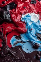 Abstract swirls of red, blue, black, and white paint creating a dynamic marbled texture with glossy finish for artistic backgrounds.