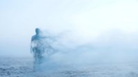 Young adult male figure emerging from misty ocean waters, ethereal and atmospheric scene with cool blue tones, suitable for conceptual, editorial, wellness, and spiritual design projects.