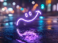 Glowing neon smile face drawn with light on wet asphalt surface at night with bokeh city lights creating magical urban atmosphere and reflection.