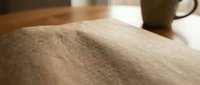 Close-up of fine sand texture with smooth grains and natural shadows creating depth and dimension for construction and material backgrounds.