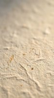 Soft golden sand texture with natural patterns and gentle lighting creating warm beach atmosphere for summer vacation and travel concepts.
