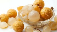 Fresh lychee fruits with peeled translucent flesh in glass bowl, exotic tropical Asian dessert ingredient for culinary use.