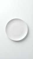 Empty white ceramic plate isolated on white background, ready for food photography, product mockups, and design compositions.