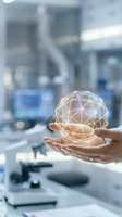 Hands holding glowing geometric sphere in modern laboratory with microscope background representing scientific innovation and digital technology research.
