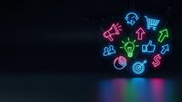 Colorful neon business icons glowing on dark background with reflection, featuring marketing symbols for digital commerce and corporate strategy.