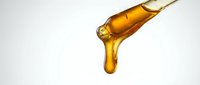 Golden oil dripping from bottle dropper against white background, suitable for cosmetics, skincare, wellness and beauty product packaging design.