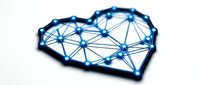 Heart-shaped network with glowing blue nodes and connecting lines representing digital connectivity, technology infrastructure, and data communication systems.