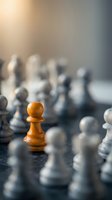 Orange wooden chess pawn stands out among blurred white and black pieces on board, symbolizing leadership, strategy, and standing apart from crowd.