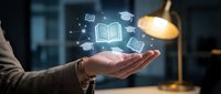 Businessman holding open book with glowing education icons floating above palm, representing online learning, digital knowledge, and e-learning solutions for corporate training.