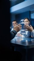 Business professionals collaborating on digital network diagram in modern office meeting room for strategic planning and teamwork solutions.