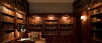 Elegant home library with wooden bookshelves, warm lighting and leather armchair creating cozy reading atmosphere for luxury interior design projects.