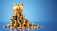 Golden piggy bank sitting on stack of coins against blue gradient background for savings and financial planning concepts.