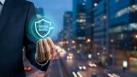 Businessman hand touching glowing control rights shield icon over blurred city street at night for data protection and digital security management.