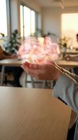 Glowing pink brain hologram floating above open palm in modern office space representing artificial intelligence and mental health innovation.